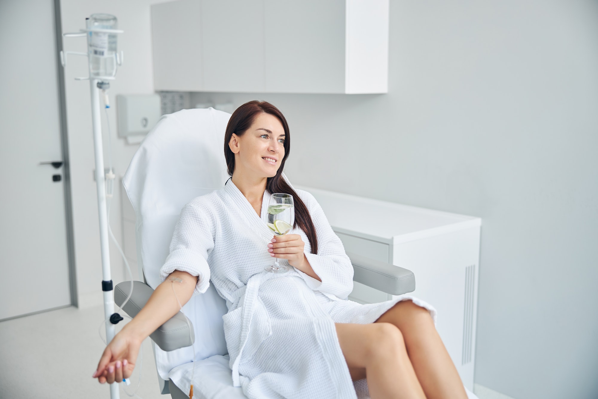 Happy adult patient relaxing during the intravenous therapy
